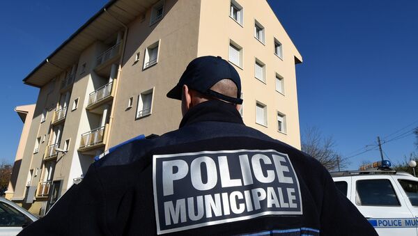 A municipal police officer stands January 22, 2015 in front of a building in Beziers, southern France, where a Russian Chechen suspected of preparing a terrorist attack was living before his January 19 arrest - Sputnik International