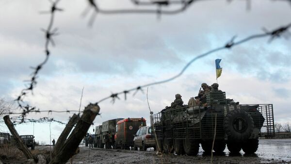 A Ukrainian military convoy is pictured through a barbed wire fence at a military base in the town of Kramatorsk, eastern Ukraine - Sputnik International