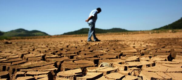 A worker from the Sao Paulo state company that provides water and sewage services to residential, commercial and industrial areas looks at the cracked ground of near Jaguary dam in Braganca Paulista, 100 km from Sao Paulo, in this file photo taken January 31, 2014 A worker from the Sao Paulo state company that provides water and sewage services to residential, commercial and industrial areas looks at the cracked ground of near Jaguary dam in Braganca Paulista, 100 km from Sao Paulo, in this file photo taken January 31, 2014 - Sputnik International