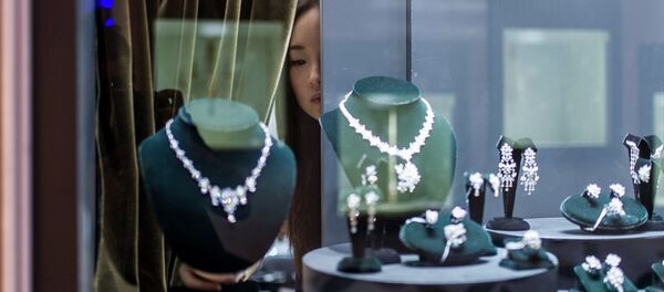 A vendor checks a display prior to the opening of the Hong Kong Jewellery and Gem fair at the convention and exhibition Centre on September 17, 2014 A vendor checks a display prior to the opening of the Hong Kong Jewellery and Gem fair at the convention and exhibition Centre on September 17, 2014 - Sputnik International