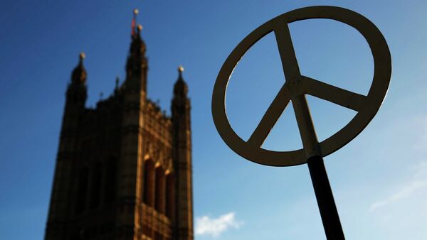 A sign with the peace symbol is seen during a peace rally against nuclear weapons in front of the Houses of Parliament in London January 24, 2015 - Sputnik International