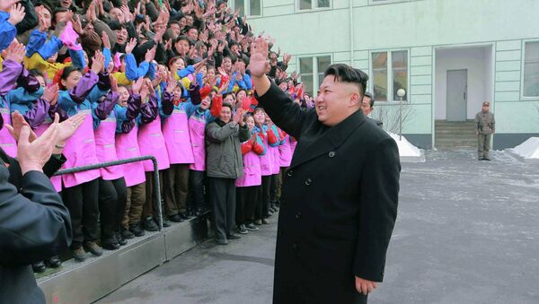 North Korean leader Kim Jong Un waves to a crowd as he provides field guidance to the Ryuwon Shoes Factory in this undated photo released by North Korea's Korean Central News Agency (KCNA) in Pyongyang January 21, 2015 - Sputnik International