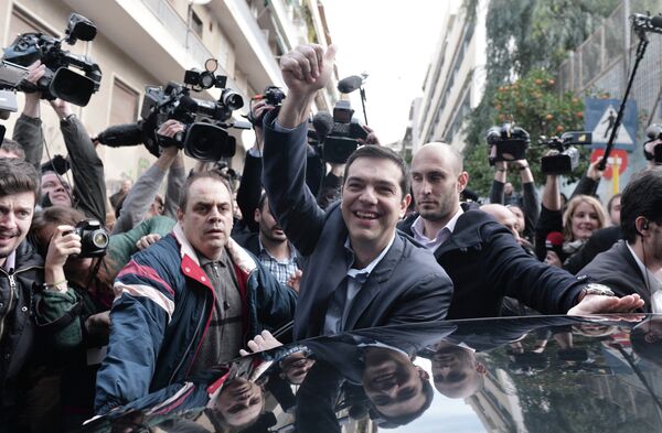 The leader of Greece's left-wing Syriza party Alexis Tsipras waves as he leaves after voting at a polling station in Athens on January, 2015. The leader of Greece's left-wing Syriza party Alexis Tsipras waves as he leaves after voting at a polling station in Athens on January, 2015. - Sputnik International