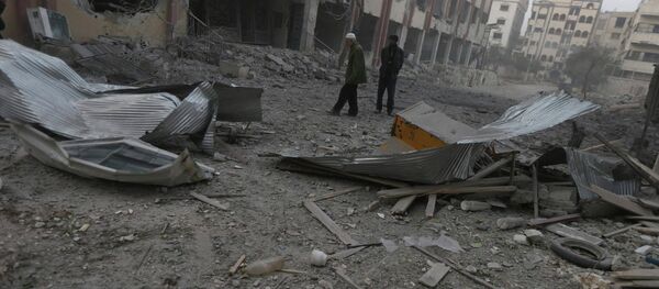 Residents inspect a damaged site after what activists said were air strikes by forces loyal to Syria's President Bashar al-Assad in Douma eastern Al-Ghouta, near Damascus January 25, 2015 Residents inspect a damaged site after what activists said were air strikes by forces loyal to Syria's President Bashar al-Assad in Douma eastern Al-Ghouta, near Damascus January 25, 2015 - Sputnik International