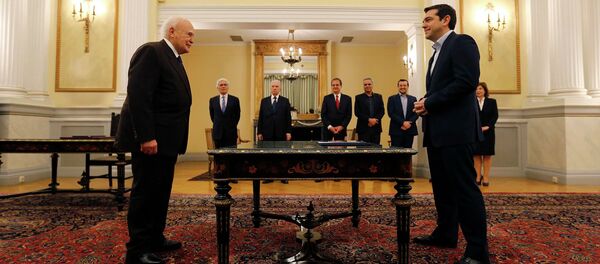 Head of radical leftist Syriza party and winner of the Greek parliamentary elections Alexis Tsipras (R) stands in front of Greek President Karolos Papoulias in the Presidential Palace in Athens during a swearing in ceremony as Greece's first leftist Prime Minister - Sputnik International
