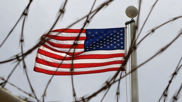 An American Flag is seen through razor wire at Camp VI in Camp Delta where detainees are housed at Naval Station Guantanamo Bay in Cuba - Sputnik International