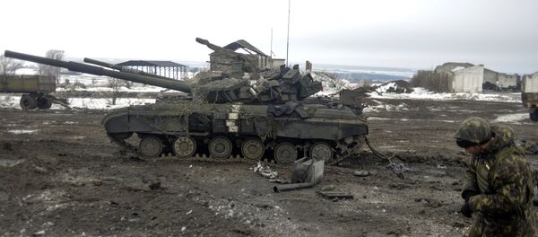A Ukrainian soldier examines a crater after shelling near Debaltseve, in the Donetsk region A Ukrainian soldier examines a crater after shelling near Debaltseve, in the Donetsk region - Sputnik International