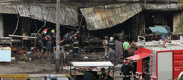 Security forces inspect the site of a twin bombing at a crowded market in Baghdad Iraq, Friday Security forces inspect the site of a twin bombing at a crowded market in Baghdad Iraq, Friday - Sputnik International