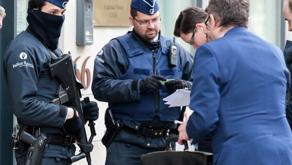 Police checks the identity of people who want to enter a government building in Brussels, Friday, Jan. 16, 2015 - Sputnik International