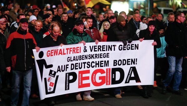 Participants hold a banner during a demonstration called by anti-immigration group PEGIDA, a German abbreviation for Patriotic Europeans against the Islamization of the West, in Dresden December 15, 2014 - Sputnik International