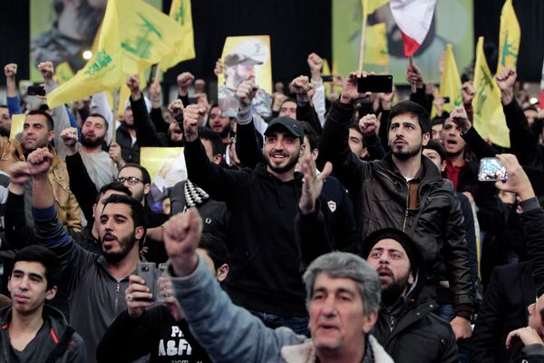 Hezbollah supporters raise their hands in salute as their leader Sheikh Hassan Nasrallah Hezbollah supporters raise their hands in salute as their leader Sheikh Hassan Nasrallah - Sputnik International