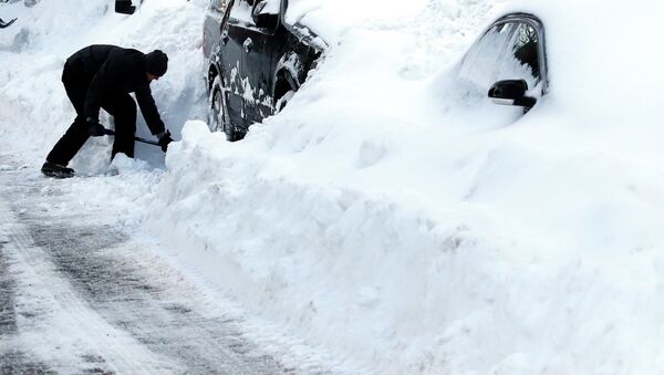 Max Gomez shovels his vehicle out at his home in Boston's Charlestown section, Wednesday, Jan. 28, 2015, one day after a blizzard dumped about two feet of snow in the city - Sputnik International