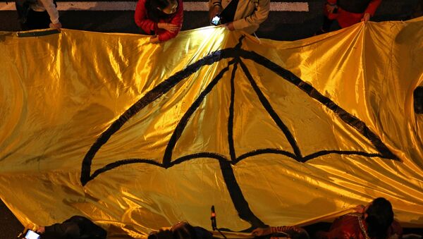 Protesters carry a long yellow banner during a march with an umbrella -- a recent symbol of Hong Kong's democracy movement - Sputnik International