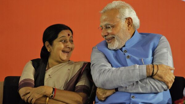 Opposition Bharatiya Janata Party (BJP) leader and India's next prime minister Narendra Modi, right, has a laugh with party leader Sushma Swaraj - Sputnik International