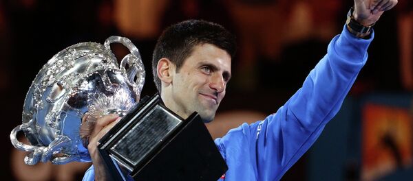 Novak Djokovic of Serbia holds the trophy after defeating Andy Murray of Britain in the men's singles final at the Australian Open tennis championship in Melbourne, Australia - Sputnik International