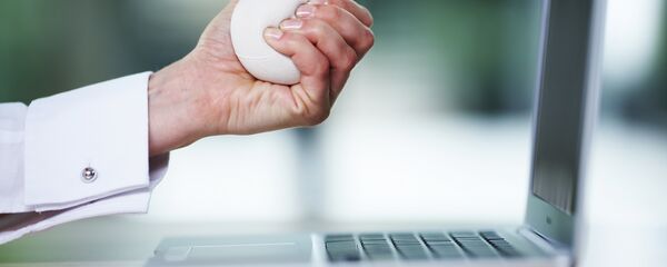 Business woman squeezing stress ball over desk, close-up Business woman squeezing stress ball over desk, close-up - Sputnik International