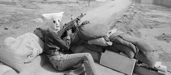 Hooded gunmen supporting Iran's central Islamic government, waiting on rooftop position in Khoramshahr, Iran on Friday, June 1, 1979 - Sputnik International