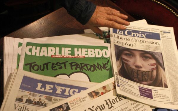 Copies of the latest issue of Charlie Hebdo newspaper are sold with other newspapers at a newsstand in Lille, northern France - Sputnik International