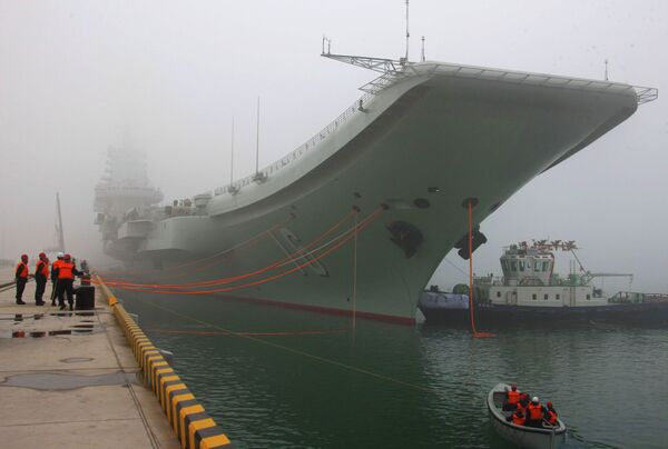 China's first aircraft carrier, the Liaoning, is anchored in the northern port in Qingdao, east China's Shandong Province, Wednesday, Feb. 27, 2013 - Sputnik International