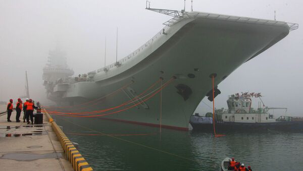 China's first aircraft carrier, the Liaoning, is anchored in the northern port in Qingdao, east China's Shandong Province, Wednesday, Feb. 27, 2013 - Sputnik International