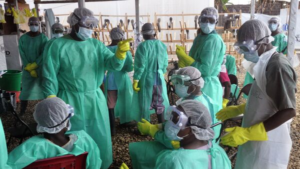 Health care workers inside a USAID-funded Ebola clinic with their Ebola virus protective gear in Liberia - Sputnik International