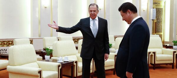 Russian Foreign Minister Sergey Lavrov, left, gestures to Chinese President Xi Jinping as Russian delegation members arrive for a meeting at the Great Hall of the People in Beijing Monday, Feb. 2, 2015 - Sputnik International