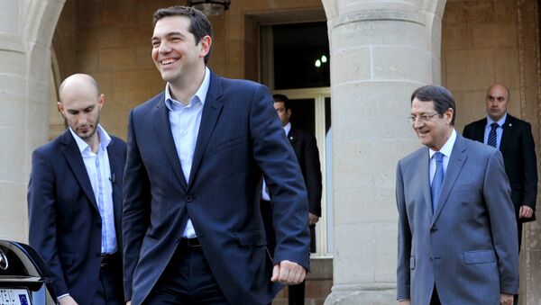 Greece's new Prime Minister Alexis Tsipras (2nd from L) leaves the presidential palace after a meeting with Cypriot President Nicos Anastasiades (R) - Sputnik International