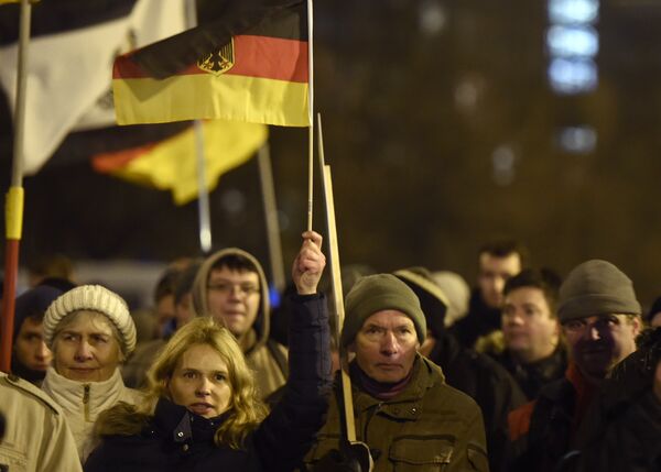 Anti-Islam protesters hold German flags during a BERGIDA rally, a local copycat of Dresden's right-wing populist movement PEGIDA (Patriotic Europeans Against the Islamisation of the Occident), at Alexander Platz in Berlin, eastern Germany Anti-Islam protesters hold German flags during a BERGIDA rally, a local copycat of Dresden's right-wing populist movement PEGIDA (Patriotic Europeans Against the Islamisation of the Occident), at Alexander Platz in Berlin, eastern Germany - Sputnik International
