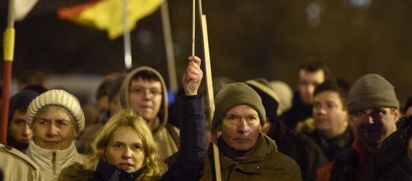 Anti-Islam protesters hold German flags during a BERGIDA rally, a local copycat of Dresden's right-wing populist movement PEGIDA (Patriotic Europeans Against the Islamisation of the Occident), at Alexander Platz in Berlin, eastern Germany Anti-Islam protesters hold German flags during a BERGIDA rally, a local copycat of Dresden's right-wing populist movement PEGIDA (Patriotic Europeans Against the Islamisation of the Occident), at Alexander Platz in Berlin, eastern Germany - Sputnik International