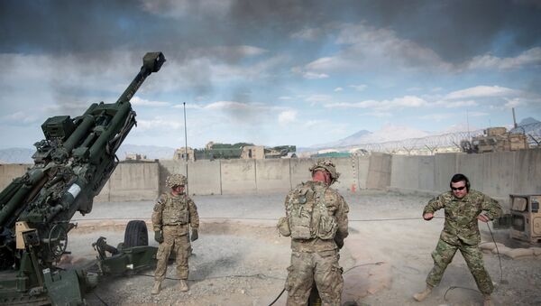 This photo taken on May 28, 2014 shows US Army Sergeant (retired) Joshua Ben, of Missouri (R) who lost his leg to an Rocket Propelled Grenade (RPG) in Afghanistan’s Jalrez Valley in 2007, firing artillery during 'Operation Proper Exit' at Forward Operating Base Shank in Afghanistan's Logar Province - Sputnik International