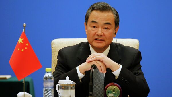 Chinese Foreign Minister Wang Yi speaks during the 13th Russia-India-China Foreign Ministers' Meeting, at Diaoyutai State Guesthouse in Beijing - Sputnik International