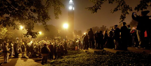 Protesters gather around the St. Louis University campus clock tower after a march through the streets of St. Louis, protesting against the recent shootings of two young black men by law enforcement officers, early Monday, Oct. 13, 2014. Protesters gather around the St. Louis University campus clock tower after a march through the streets of St. Louis, protesting against the recent shootings of two young black men by law enforcement officers, early Monday, Oct. 13, 2014. - Sputnik International