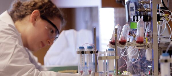 A researcher works near a blood test machine recently developed which is so sensitive it can spot a singe cancer cell lurking among a billion healthy ones during a media availability - Sputnik International