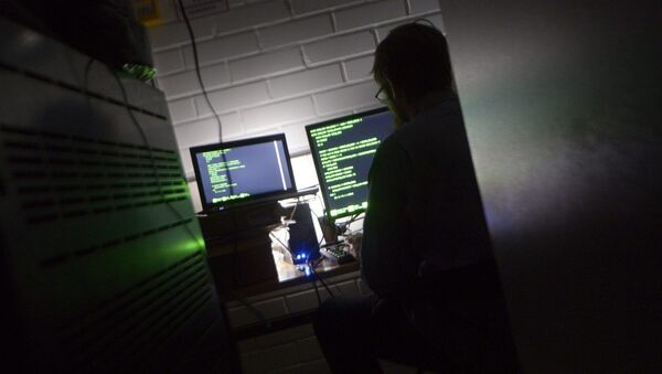 A man types on a keyboard in a computer server room - Sputnik International