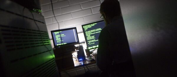 A man types on a keyboard in a computer server room A man types on a keyboard in a computer server room - Sputnik International