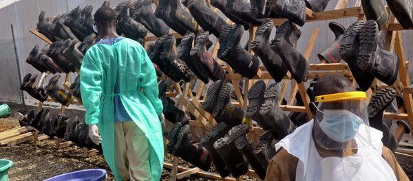 Health care workers walk past boots that were washed to prevent the spread of the Ebola virus inside a USAID, funded Ebola clinic in Monrovia, Liberia, Friday, Jan. 30, 2015. The World Health Organization says officials are now focused on ending the biggest-ever Ebola outbreak rather than just slowing the virus’ spread. Health care workers walk past boots that were washed to prevent the spread of the Ebola virus inside a USAID, funded Ebola clinic in Monrovia, Liberia, Friday, Jan. 30, 2015. The World Health Organization says officials are now focused on ending the biggest-ever Ebola outbreak rather than just slowing the virus’ spread. - Sputnik International