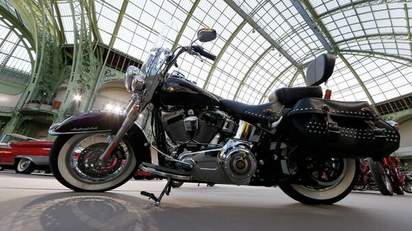 A Harley-Davidson motorcycle blessed with the signature of Emeritus Pope Benedict XVI, and later received by Pope Francis, is displayed ahead of the Bonhams' Les Grandes Marques du Monde vintage motor cars and motorcycles auction at the Grand Palais exhibition hall as part of the Retromobile vintage car show in Paris February 4, 2015 - Sputnik International