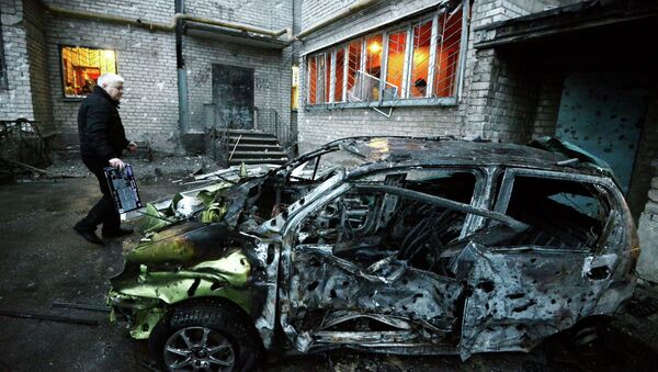 A man stands next to his car in the eastern Ukrainian city of Donetsk - Sputnik International