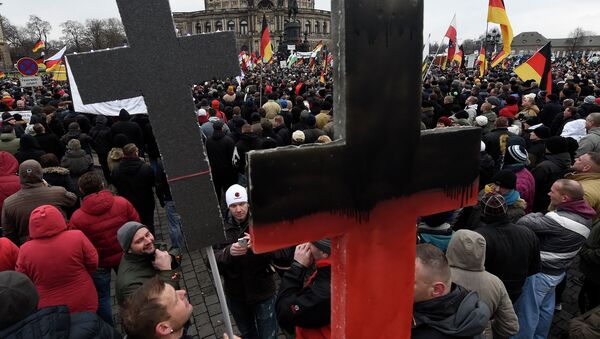 Demonstrators show crosses during a rally of the group Patriotic Europeans against the Islamisation of the West, or PEGIDA - Sputnik International