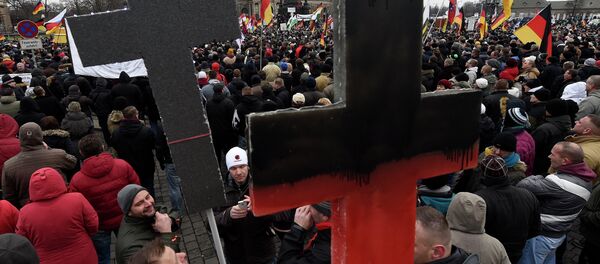 Demonstrators show crosses during a rally of the group Patriotic Europeans against the Islamisation of the West, or PEGIDA Demonstrators show crosses during a rally of the group Patriotic Europeans against the Islamisation of the West, or PEGIDA - Sputnik International