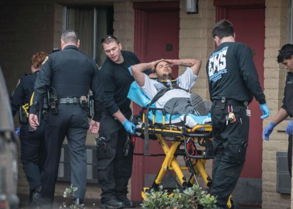 Paramedics transport Justin Reynolds after he was shot by his 3-year-old son. Paramedics transport Justin Reynolds after he was shot by his 3-year-old son. - Sputnik International