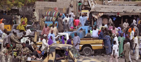 In this file photo taken Tuesday, Jan. 27, 2015, Nigerian Soldiers, left, pass by on the back of a armed truck as they patrol at a local market after recent violence in surrounding areas at Maiduguri, Nigeria In this file photo taken Tuesday, Jan. 27, 2015, Nigerian Soldiers, left, pass by on the back of a armed truck as they patrol at a local market after recent violence in surrounding areas at Maiduguri, Nigeria - Sputnik International