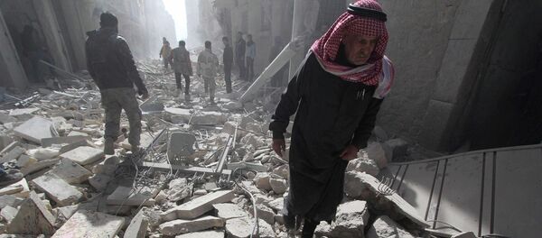 A man walks on debris as blood covers rubble of damaged buildings, at a site hit by what activists said was a barrel bomb dropped by forces loyal to Syria's President Bashar al-Assad, in the al-Myassar neighbourhood of Aleppo A man walks on debris as blood covers rubble of damaged buildings, at a site hit by what activists said was a barrel bomb dropped by forces loyal to Syria's President Bashar al-Assad, in the al-Myassar neighbourhood of Aleppo - Sputnik International