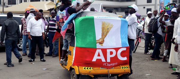 Men ride on a transport wrapped with a banner campaigning for All Progressives Congress (APC) outside a campaign rally in Yaba district in Lagos February 5, 2015 Men ride on a transport wrapped with a banner campaigning for All Progressives Congress (APC) outside a campaign rally in Yaba district in Lagos February 5, 2015 - Sputnik International