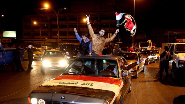In this Saturday, Feb. 7, 2015 photo, Iraqis celebrate after the lifting of the night-time curfew at Tahrir Square in Baghdad, Iraq - Sputnik International