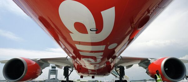 A security officer (R) stands by AirAsia X's first leased Airbus A330 long-haul aircraft as it sits on the tarmac of the Kuala Lumpur International Airport. File photo. A security officer (R) stands by AirAsia X's first leased Airbus A330 long-haul aircraft as it sits on the tarmac of the Kuala Lumpur International Airport. File photo. - Sputnik International