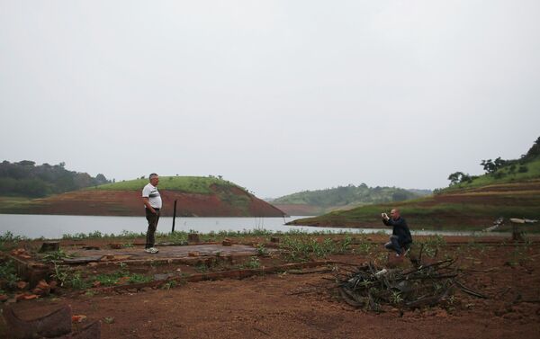 Tourists take pictures on the square of the re-emerging old city of Igarata in front of Jaguari reservoir, in Igarata, Sao Paulo State, February 4, 2015 - Sputnik International