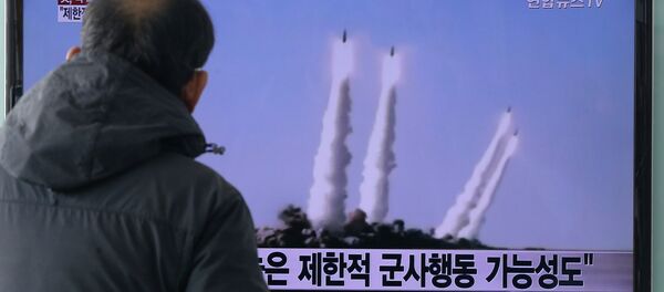 A man watches a TV news program showing the file footage of the missile launch conducted by North Korea, at Seoul Railway Station in Seoul, South Korea, Monday, Feb. 9, 2015 - Sputnik International