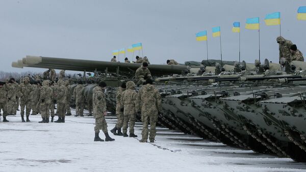 Ukrainian servicemen stand near armored vehicles during a ceremony with Ukrainian President Petro Poroshenko to mark the delivery of more than 100 pieces of military equipment to the Ukrainian armed forces, near Zhitomir, Ukraine, Jan. 5, 2015 - Sputnik International