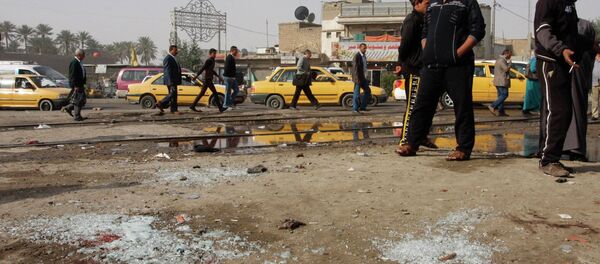 People gather at the site of a suicide bombing attack in the Shi'ite neighborhood of Kadhimiya in Baghdad February 9, 2015 People gather at the site of a suicide bombing attack in the Shi'ite neighborhood of Kadhimiya in Baghdad February 9, 2015 - Sputnik International